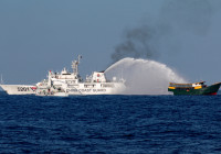FILE PHOTO: Chinese Coast Guard vessels fire water cannons towards a Philippine resupply vessel Unaizah May 4 on its way to a resupply mission at Second Thomas Shoal in the South China Sea