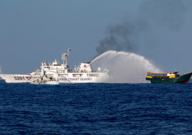 FILE PHOTO: Chinese Coast Guard vessels fire water cannons towards a Philippine resupply vessel Unaizah May 4 on its way to a resupply mission at Second Thomas Shoal in the South China Sea