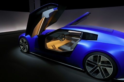 A blue Jaguar Type 00 concept car, showcasing a low-slung, muscular design.