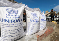 FILE PHOTO: Displaced Palestinians wait to receive United Nations Relief and Works Agency (UNRWA) aid, in Rafah